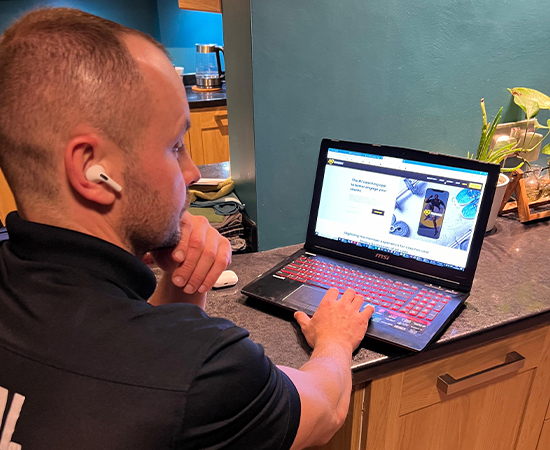 Alin reviewing an online coaching plan on a laptop
